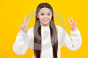 Cute teen girl showing fingers doing victory sign. Number two, v sign, peace strength fight or victory symbol and letter