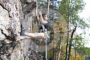 Cute teen kid climbing on rock with insurance, lifestyle sport people concept