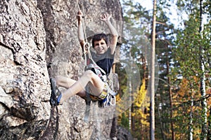 Cute teen kid climbing on rock with insurance, lifestyle sport people concept