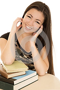 Cute teen model sitting with school books smiling