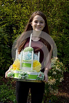 Girl brings birthday cake made of toilet paper