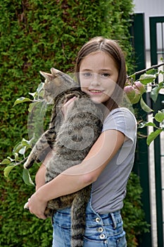 Cute teenage girl cuddles  with her cat