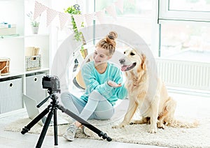 Cute teenage girl with dog blogging