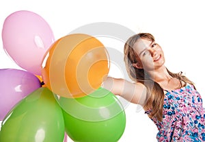 Cute teenage girl holding balloons on white