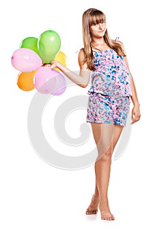 Cute teenage girl holding balloons on white