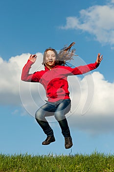 Cute teenage girl jumping with joy