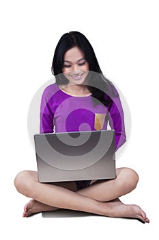 Cute teenage girl with laptop in studio