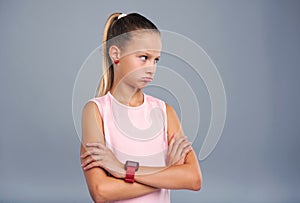 Cute teenage girl pouting and crossing her arms