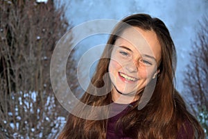 Cute teenage girl smiles with malicious joy