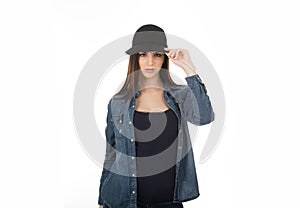 Cute teenage girl touching her hat in sign of salute