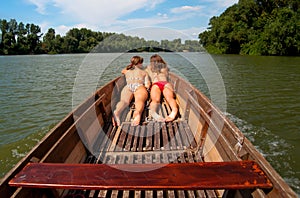 Cute teenage girls sunbathing in the boat