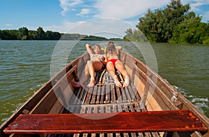 Cute teenage girls sunbathing in the boat