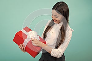Cute teenager child girl congratulate with valentines day, giving romantic gift box. Present, greeting and gifting photo