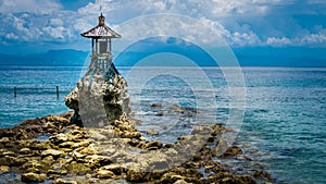 Cute Temple on the Shore by the Sea on Nusa Penida with Dramatic Clouds above Bali, Indonesia