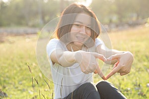 Cute Thai asian girl love heart shape with her hands