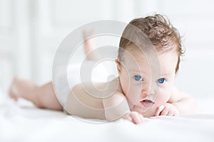 Cute tiny newborn baby enjoying her tummy time