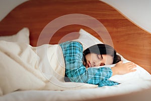 Woman Wearing Pajamas Sleeping in Her Bedroom