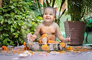 cute toddler baby boy bathing in decorated bathtub at outdoor from unique perspective