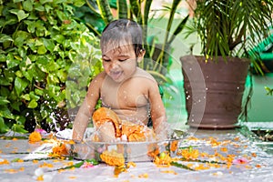 cute toddler baby boy bathing in decorated bathtub at outdoor from unique perspective