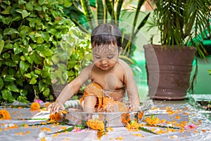 cute toddler baby boy bathing in decorated bathtub at outdoor from unique perspective