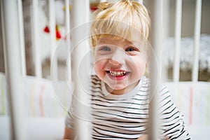 Cute toddler boy in the bedroom. Close up.