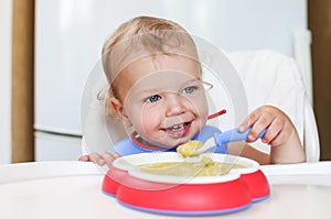 Cute toddler boy eating