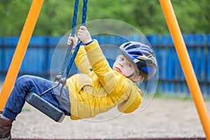 Cute toddler boy, playing on the playground photo