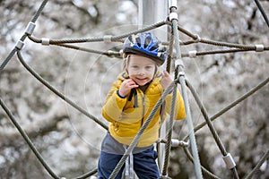 Cute toddler boy, playing on the playground photo