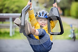 Cute toddler boy, playing on the playground photo