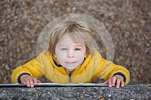 Cute toddler boy, playing on the playground photo