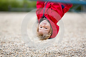 Cute toddler boy, playing on the playground photo