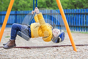 Cute toddler boy, playing on the playground photo