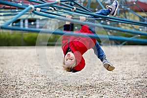 Cute toddler boy, playing on the playground photo