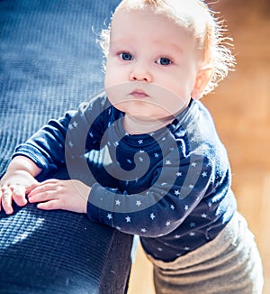 Cute toddler boy in a room posing