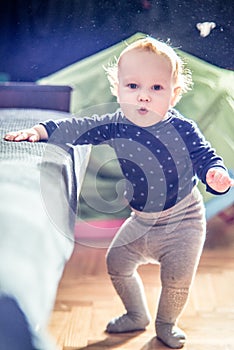 Cute toddler boy in a room posing