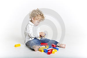 Cute toddler is building with legos