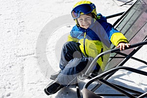 Cute toddler child in colorful ski wear, skiing in Italy on a sunny day, kids and adults skiing together