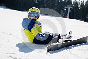 Cute toddler child in colorful ski wear, skiing in Italy on a sunny day, kids and adults skiing together