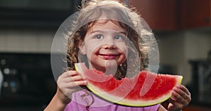Cute toddler girl eating watermelon.