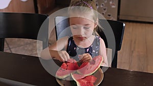 Cute toddler girl eating watermelon.