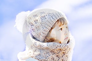 Little cute toddler girl outdoors on a sunny winter day.