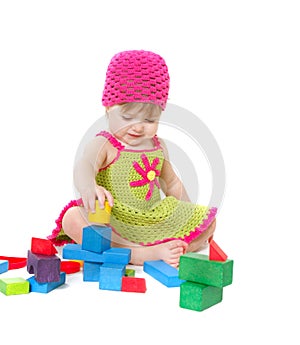 Cute toddler girl playing with building blocks