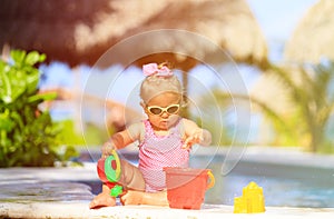 Cute toddler girl playing in swimming pool at beach