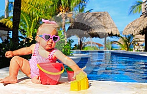 Cute toddler girl playing in swimming pool