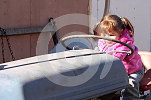 Cute Toddler Girl Playing on Tractor