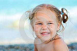 Cute toddler girl on sea background