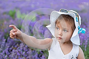 Cute toddler girl shows a finger