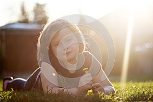 Cute toddler lying in grass