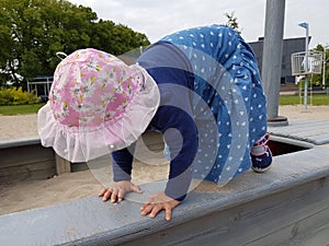 Cute toddler with pink hat and blue dress