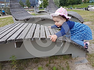 Cute toddler with pink hat and blue dress